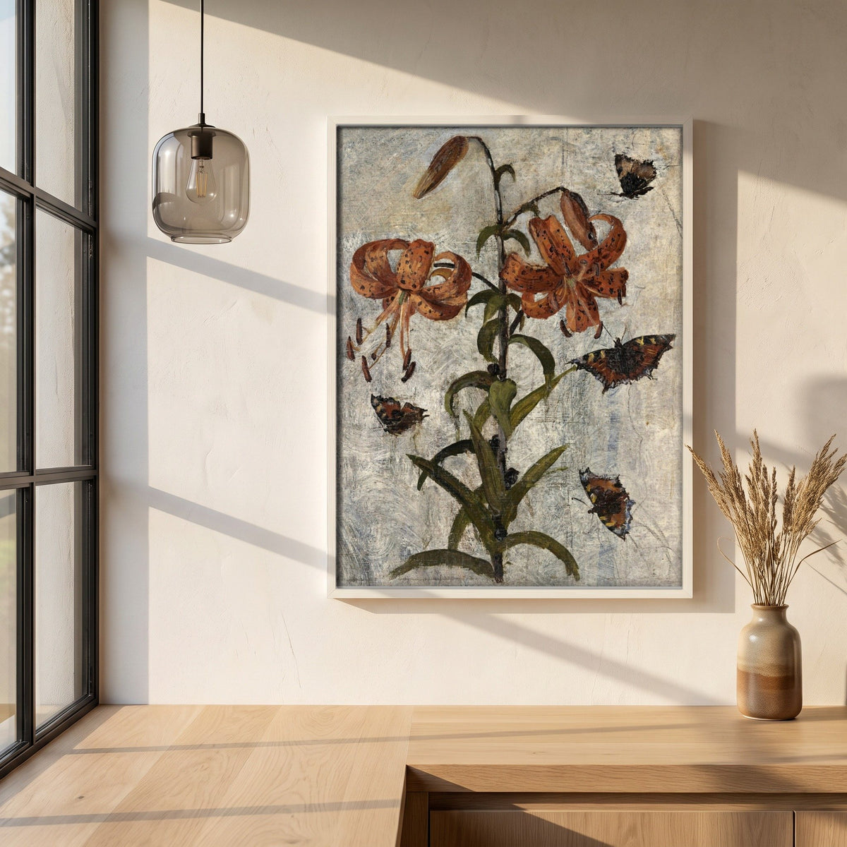 Lilies and Butterflies by Nathaniel Hone framed print in a white frame on a plaster wall above an oak worktop in a bright Scandinavian kitchen