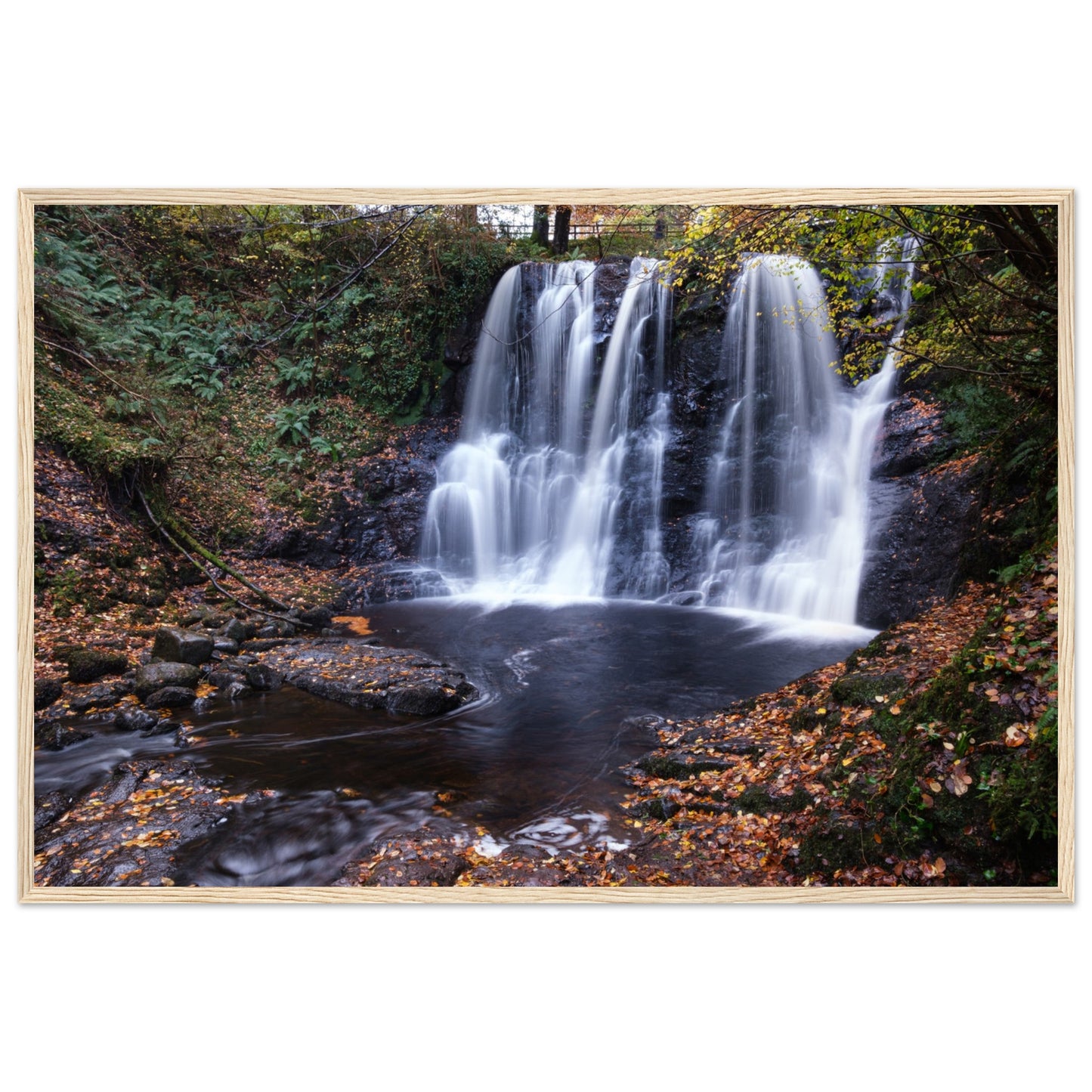 Framed print of Glenariff Waterfall, capturing the serene beauty of cascading water amidst lush greenery in the Glens of Antrim, Northern Ireland. Known as the 'Queen of the Glens,' this stunning landscape print brings nature's tranquility into your home.