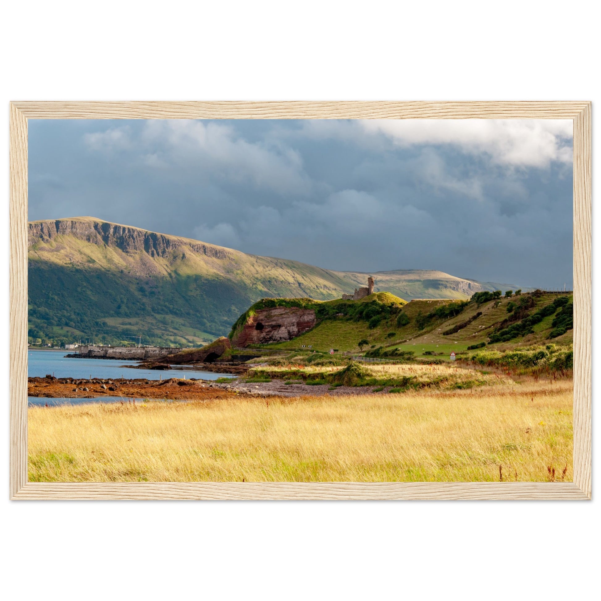 A framed print featuring Red Bay Castle amidst coastal cliffs, capturing the rugged beauty of County Antrim's Causeway Coastal Route. Historical charm meets natural grandeur in this stunning artwork.