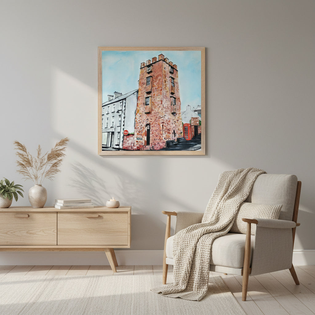 50×50 cm natural wooden framed 50×50 cm art print of The Curfew Tower Cushendall in a hygge-inspired interior, warm lighting, soft fabric textures, calming Scandinavian décor, perfect balance of lifestyle and product clarity.