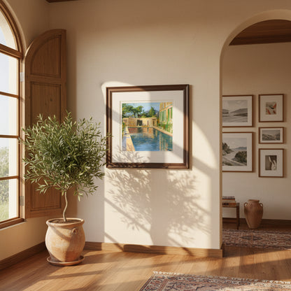 Collector’s Edition framed print of “Swimming Pool, Southern France” hanging in a sunlit Mediterranean-style interior with warm stucco walls, olive plants, soft coastal light, and a premium  hardwood frame.