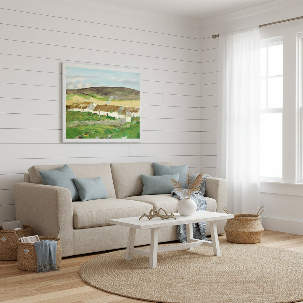 White framed Irish cottage landscape print in a bright coastal living room, linen sofa, soft blue tones, natural textures, airy and serene.