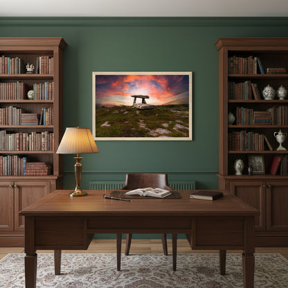 Poulnabrone Dolmen artwork in a natural wood frame above a dark oak writing desk, surrounded by bookshelves, soft lamp light and green heritage wall tones.