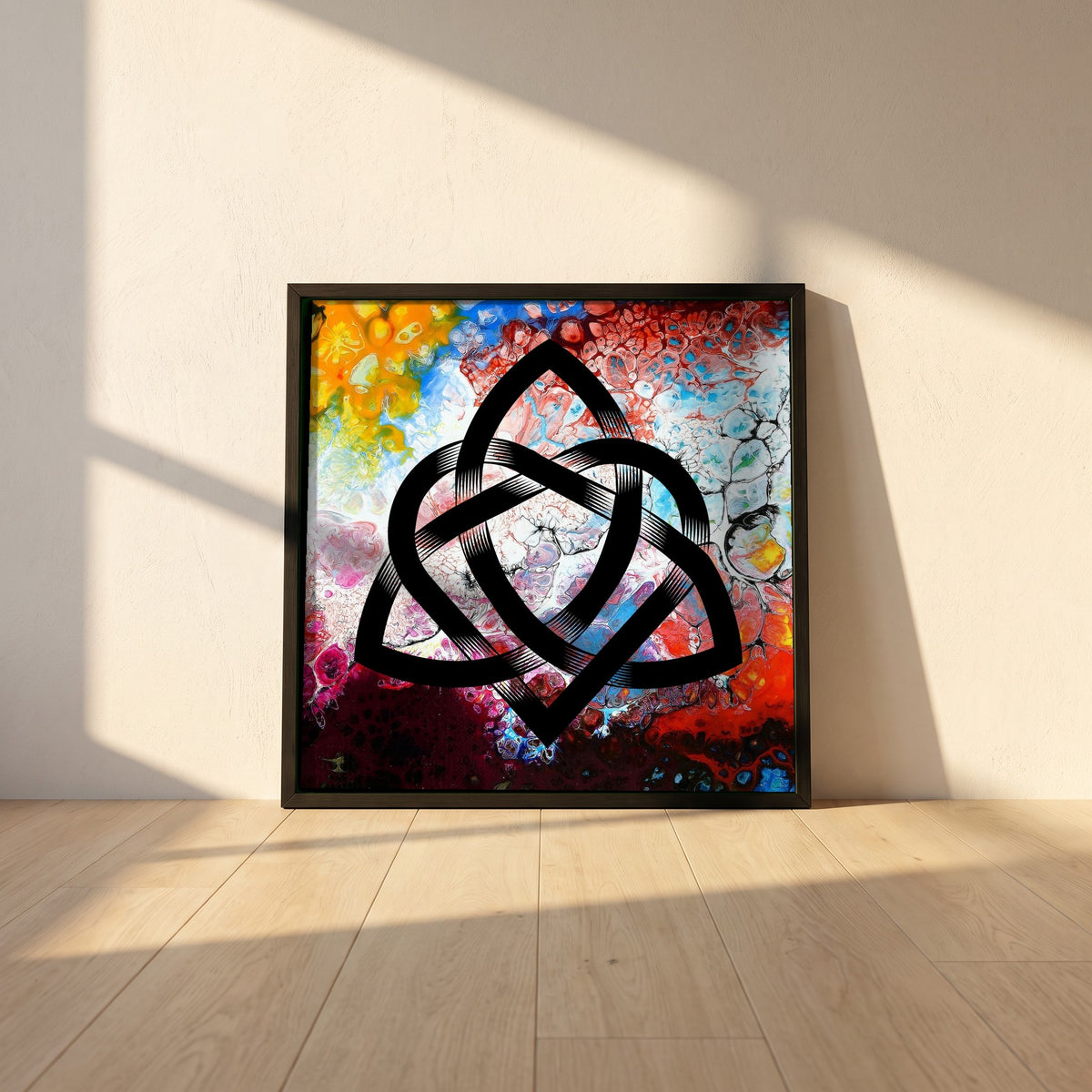 Abstract Celtic Design framed print in a black frame leaning against a white plaster wall on oak floorboards in morning light