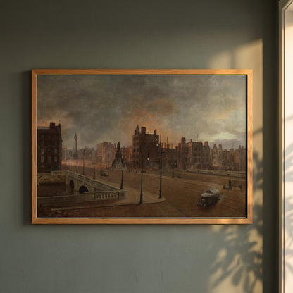 After the Bombardment framed print in a natural oak frame on a dark green wall beside a window, dappled plant shadow