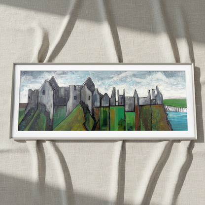 Dunluce Castle panoramic print in a pale wood frame resting on crumpled linen