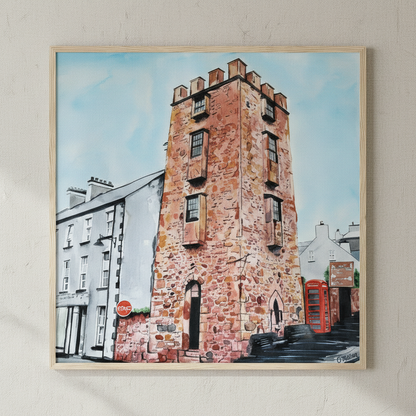 Curfew Tower Cushendall painting in a natural oak frame, close view on a warm beige wall