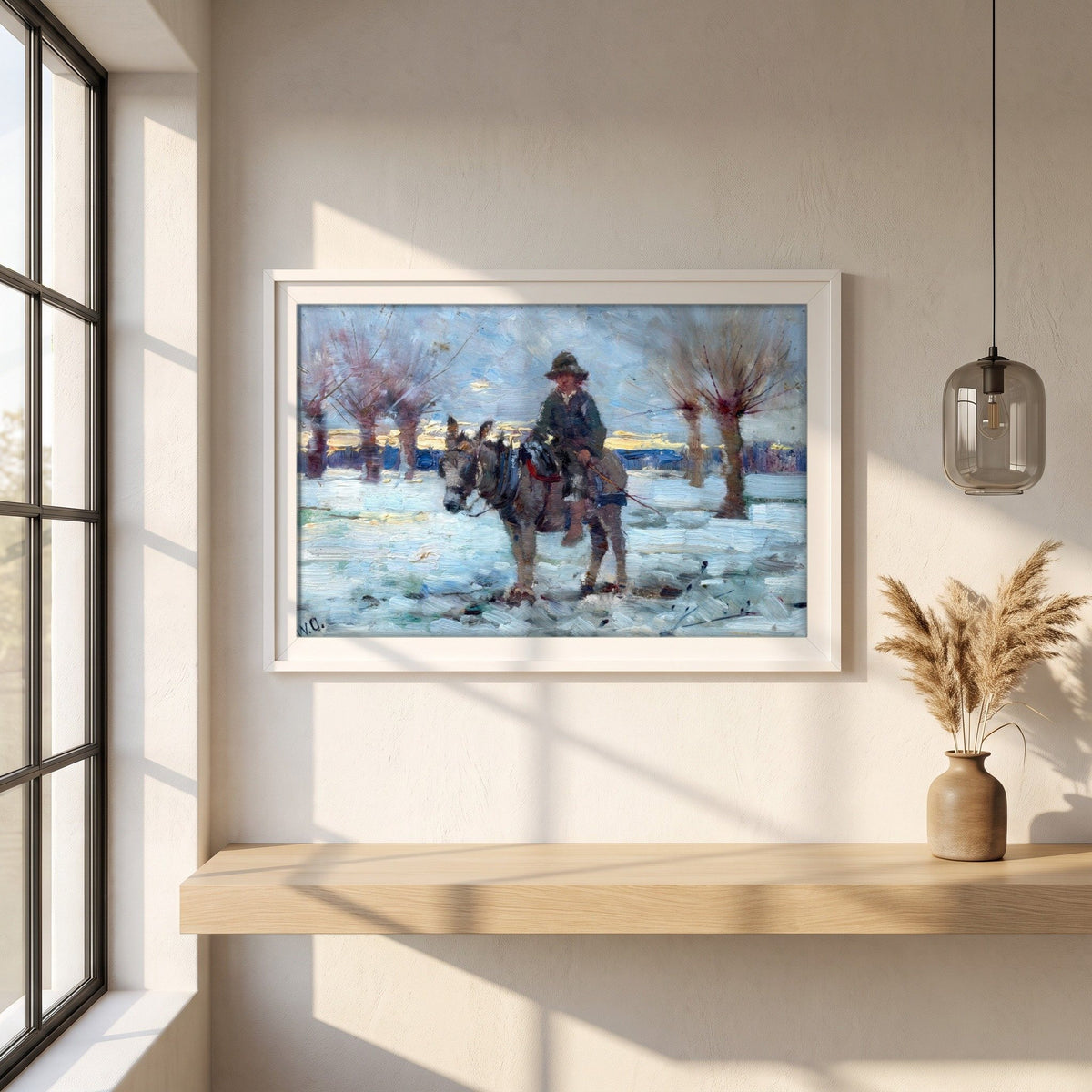 Boy on a Donkey in a Snowy Landscape by Walter Osborne framed print in a white frame on a plaster wall above an oak worktop in a bright Scandinavian kitchen