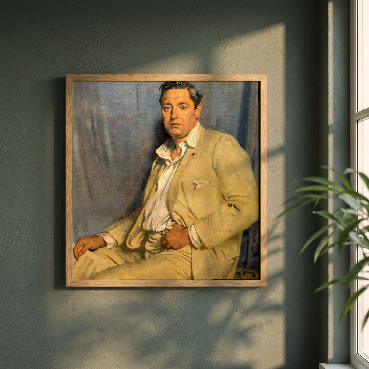 Count John McCormack framed print in a natural oak frame on a dark green wall beside a window, dappled plant shadow