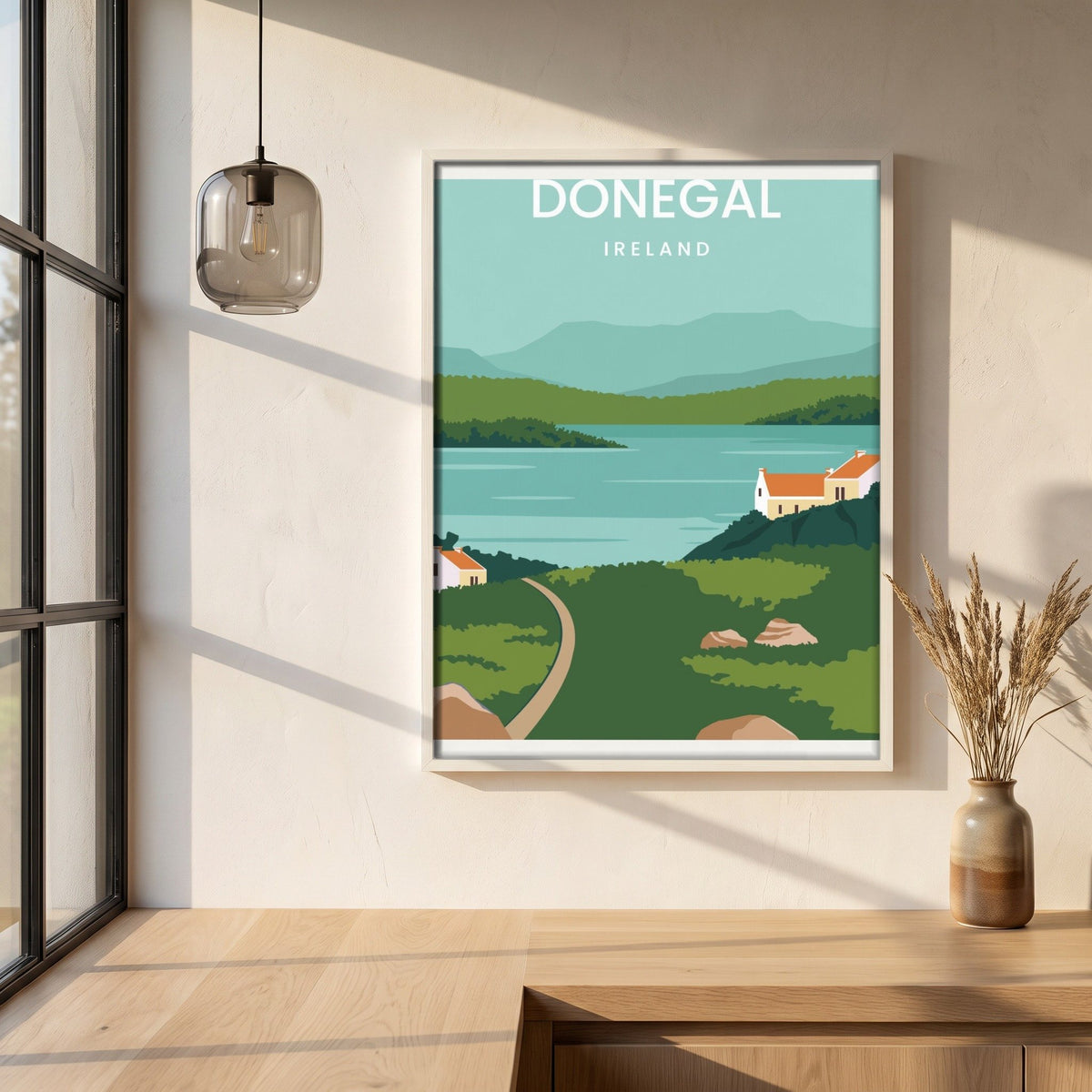 Donegal minimalist travel print in a white frame on a plaster wall above an oak worktop in a bright Scandinavian kitchen