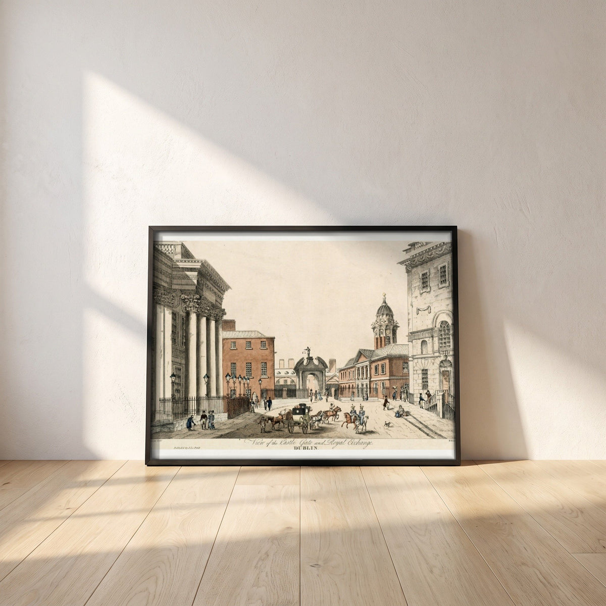 Dublin Castle Gate framed print in a black frame leaning against a white plaster wall on oak floorboards in morning light