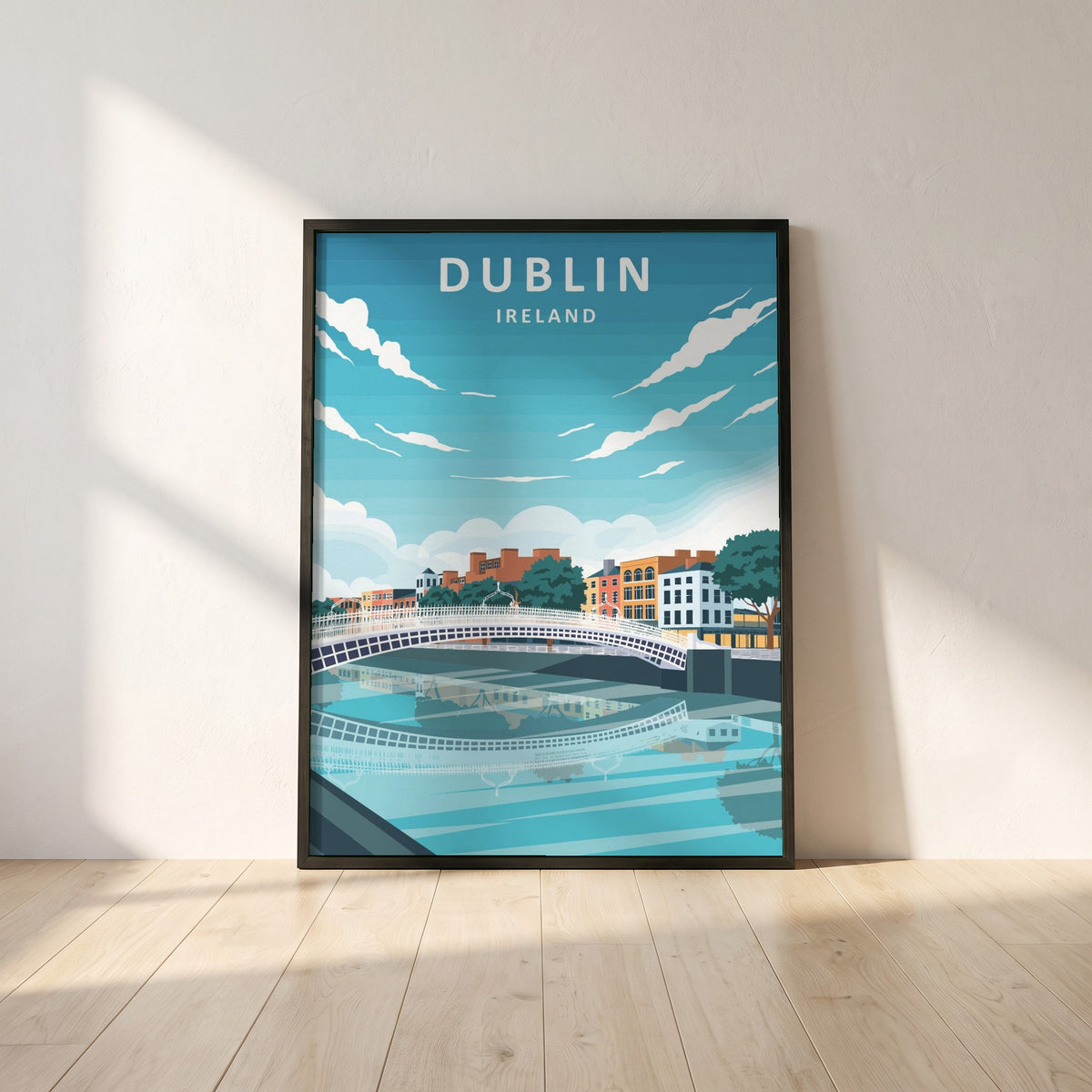 Dublin City retro travel poster framed print in a black frame leaning against a white plaster wall on oak floorboards in morning light