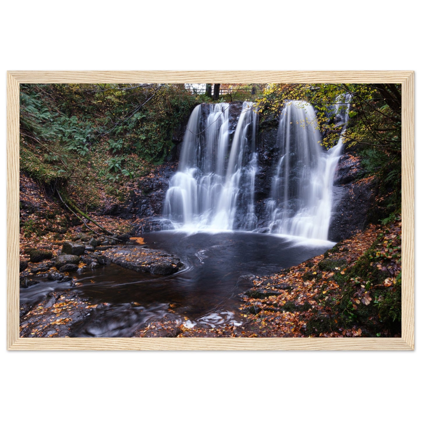 Framed print of Glenariff Waterfall, capturing the serene beauty of cascading water amidst lush greenery in the Glens of Antrim, Northern Ireland. Known as the 'Queen of the Glens,' this stunning landscape print brings nature's tranquility into your home.