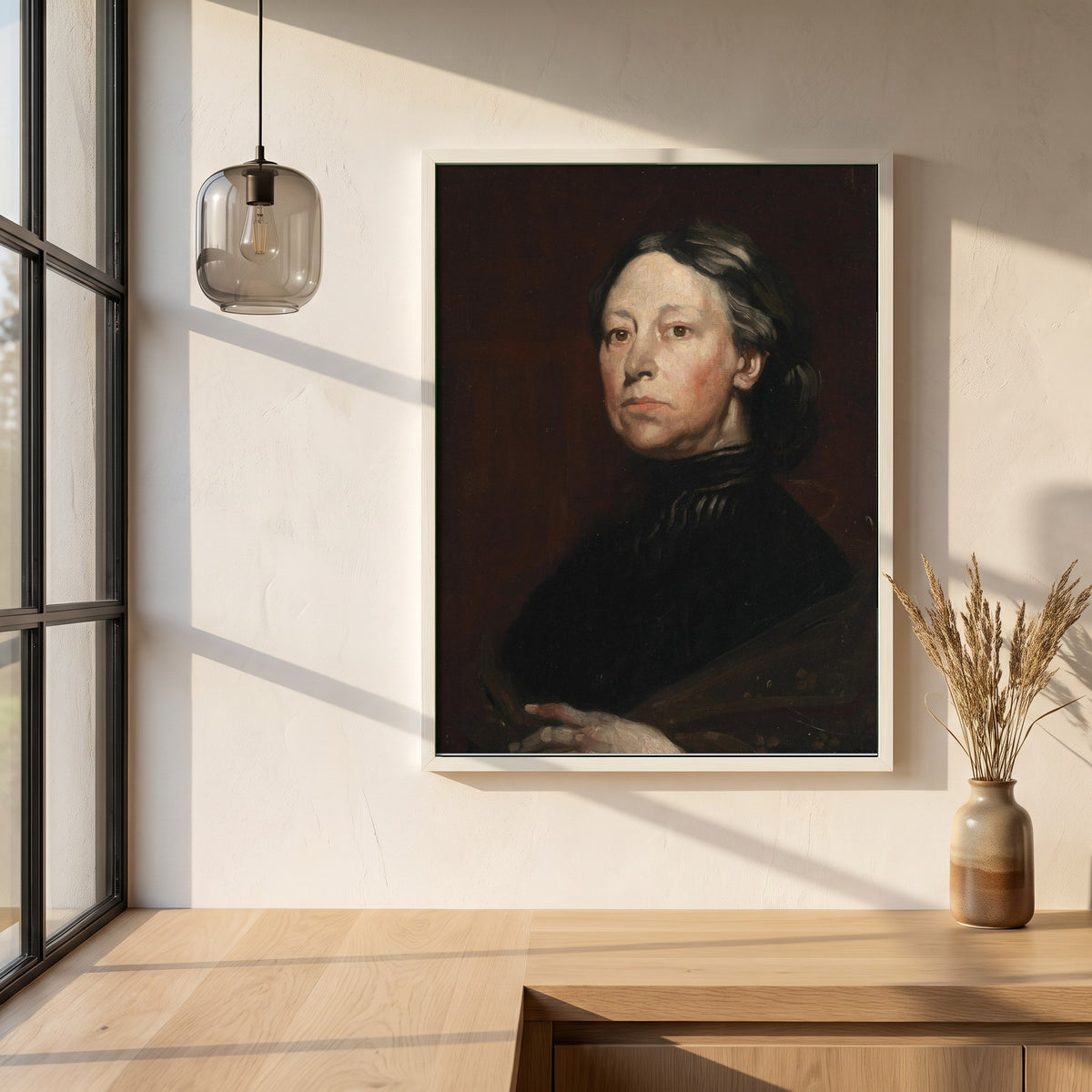 Augusta Lady Gregory framed print in a white frame on a plaster wall above an oak worktop in a bright Scandinavian kitchen