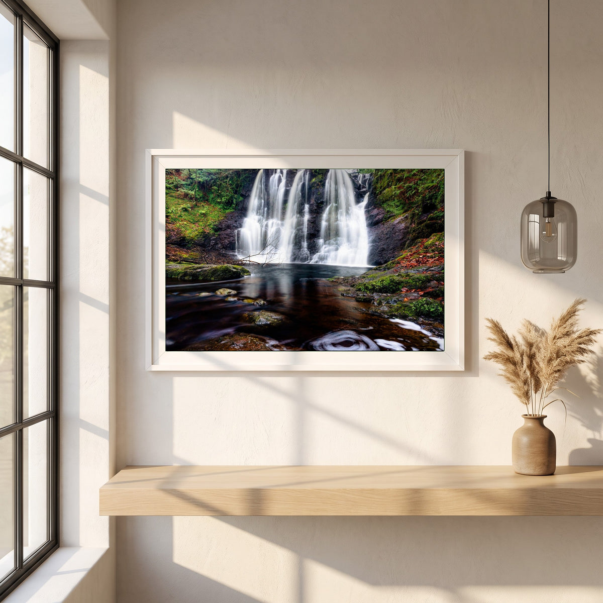 Glenariff Waterfall framed print in a white frame on a plaster wall above an oak worktop in a bright Scandinavian kitchen