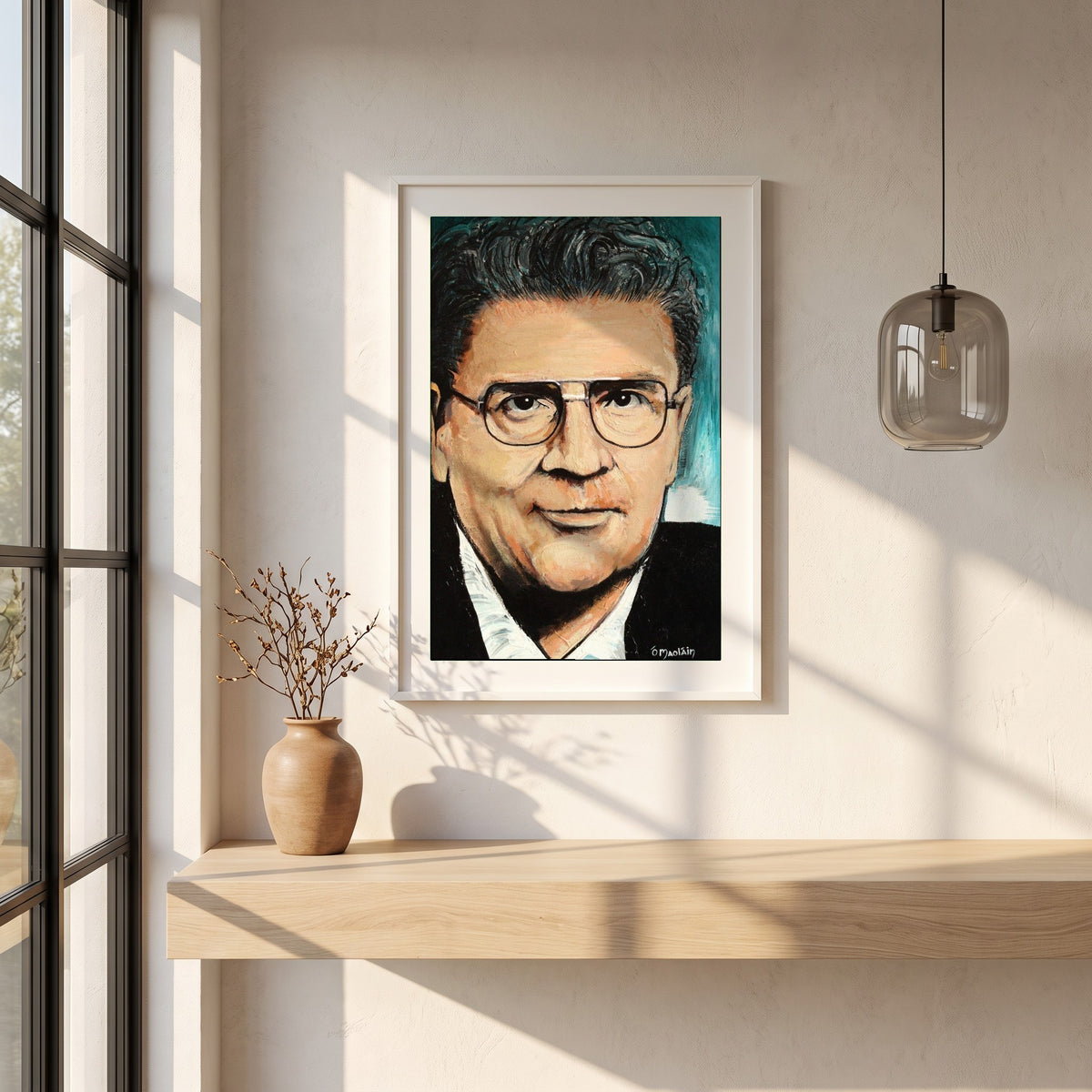 John Hume framed print in a white frame on a plaster wall above an oak worktop in a bright Scandinavian kitchen