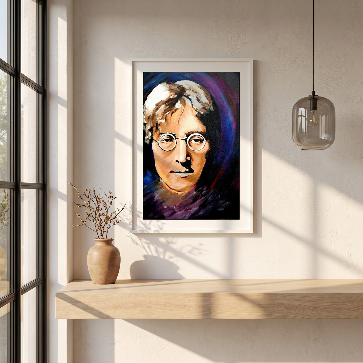 John Lennon Portrait framed print in a white frame on a plaster wall above an oak worktop in a bright Scandinavian kitchen