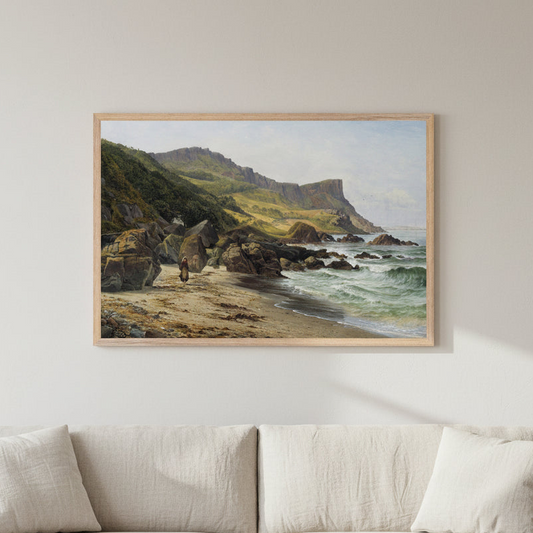 Large framed landscape print of Murlough Bay and Fair Head by Bartholomew Colles Watkins hanging above a soft neutral sofa, 60x90 cm horizontal Collector’s Edition, bright natural light, pale plaster walls, oak coffee table, subtle coastal Irish decor, focus on artwork. Buy Irish Art 
