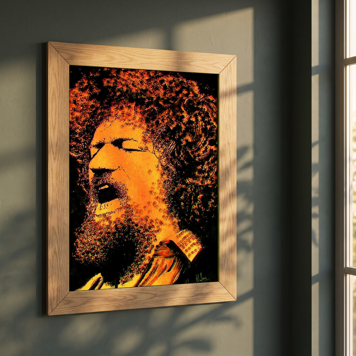 Luke Kelly framed print in a natural oak frame on a dark green wall beside a window, dappled plant shadow