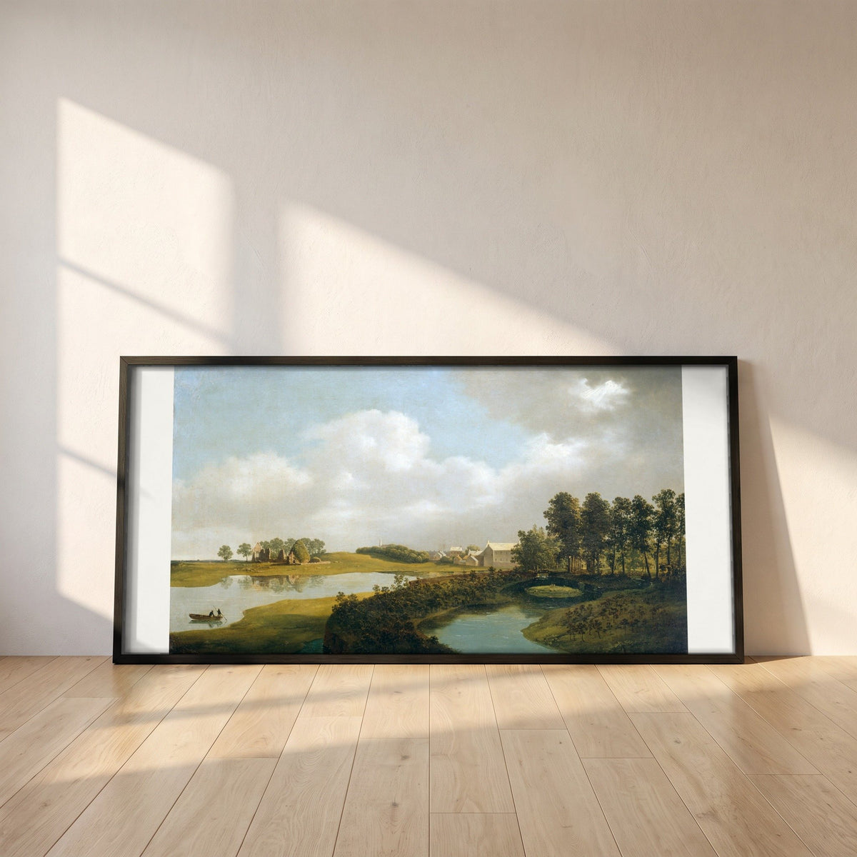 The Mill, Ballinrobe framed print in a black frame leaning against a white plaster wall on oak floorboards in morning light