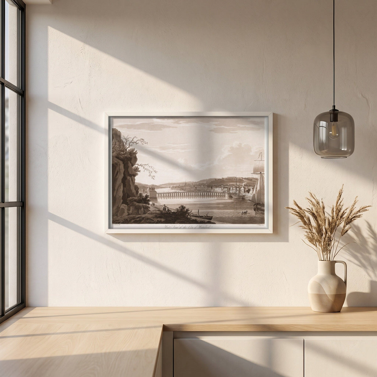 West View of the City of Waterford by Thomas Sautelle Roberts Art Print framed print in a white frame on a plaster wall above an oak worktop in a bright Scandinavian kitchen